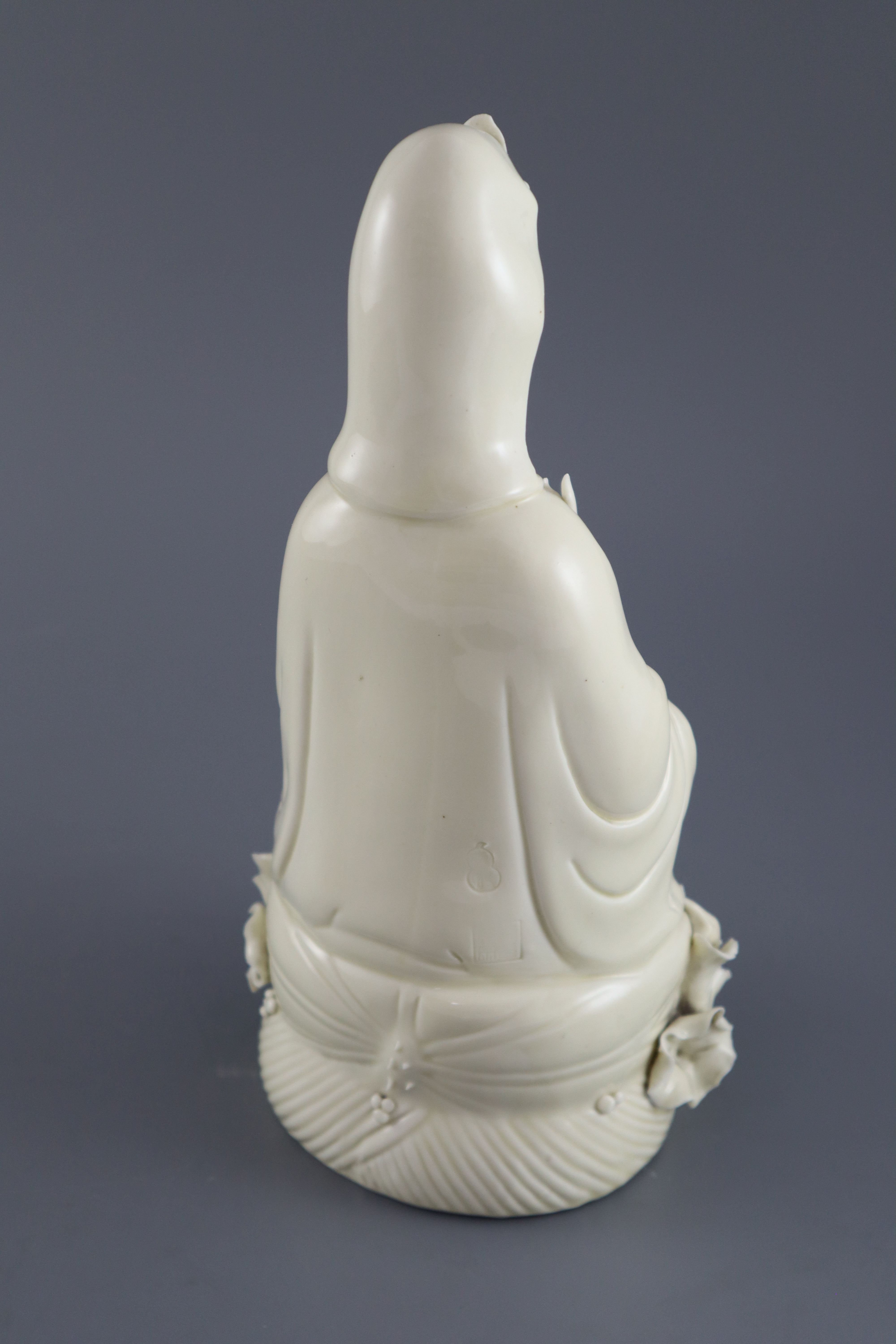 A Chinese Dehua blanc de chine figure of Guanyin, impressed seal to back, 26.5cm high